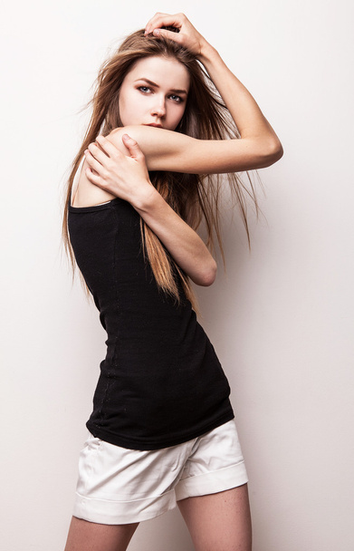 Young sensual model girl pose in studio. - Foto, afbeelding
