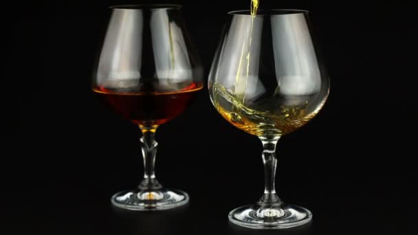 Brandy being poured into a glass on black background - Footage, Video