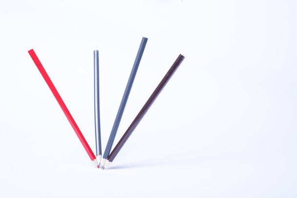 four dancing pencils as still life on white background - Фото, изображение