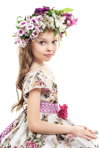 Sweet little  girl with  floral head wreath.  - Photo, Image