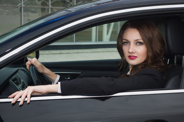 Young confident businesswoman driving car - Foto, imagen