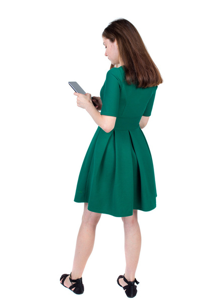 back view of standing young beautiful  woman using a mobile phon - Photo, Image