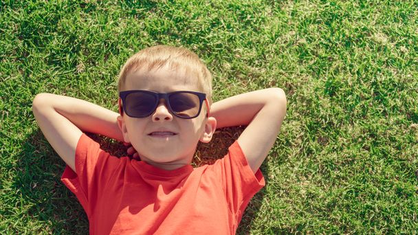 Kid relaxing on the grass  - Foto, Imagem