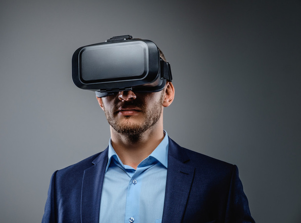 Male in a suit with virtual reality glasses - Photo, Image