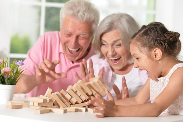 Grandparents with granddaughter playing together - Foto, immagini