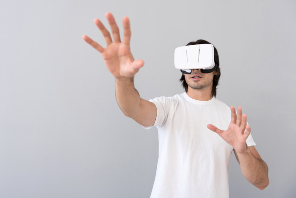 Pleasant man using virtual reality device - Foto, imagen