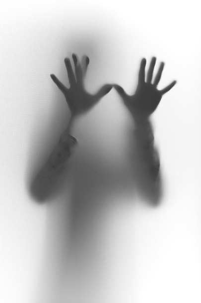 Silhouette with hands on glass - Foto, afbeelding