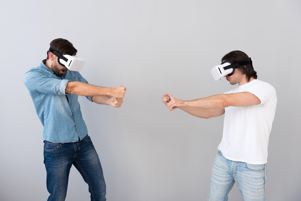 Involved men using virtual reality device - 写真・画像