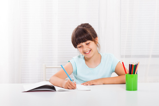 little school girl drawing  - Фото, изображение