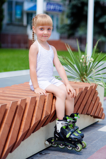 Little girl on roller skates at park - Фото, зображення