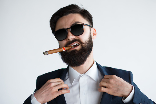 Businessman savoring success with a cigar - Foto, imagen