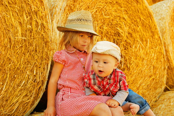 children  near bales harvest  - Valokuva, kuva