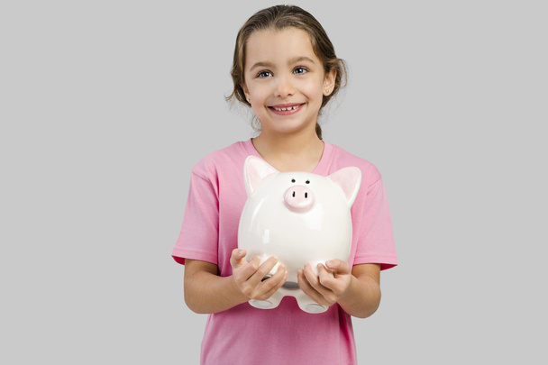 girl holding a piggybank  - Foto, Imagen