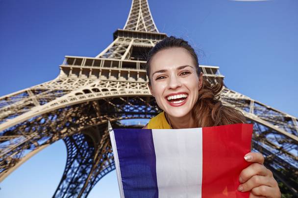 Portrait of smiling young woman showing flag in Paris, France - Foto, Imagen