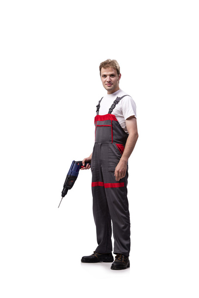 Young repairman with drill perforator isolated on white - Φωτογραφία, εικόνα