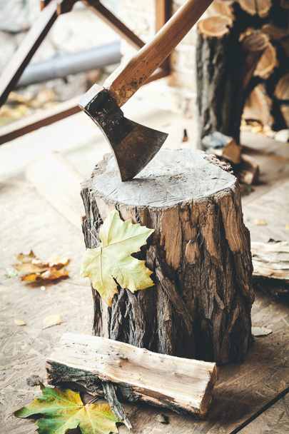 Hatchet sticking in stump, lying close to half log - Foto, imagen