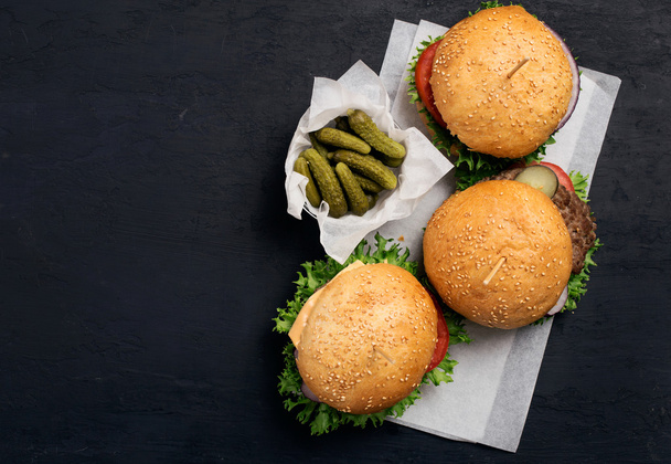 Three different burger on white paper  - Fotografie, Obrázek