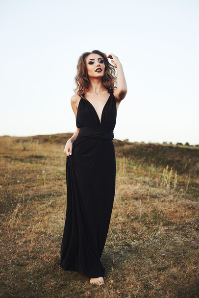 Model in black dress outdoors - Photo, image