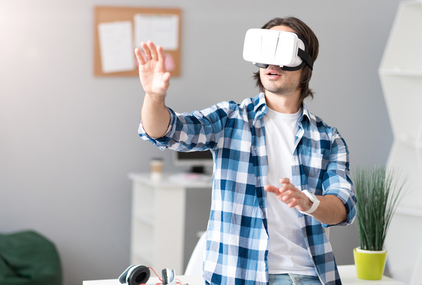 Pleasant man using virtual reality device - Foto, imagen