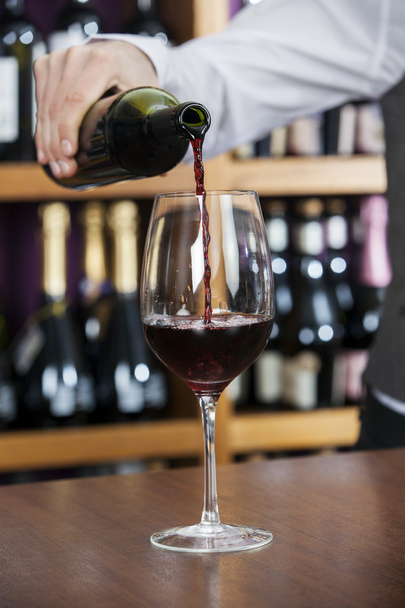 Male Bartender Pouring Red Wine In Glass - Fotografie, Obrázek
