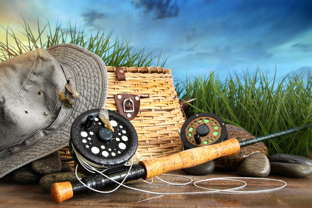 Fly fishing equipment with hat on wooden dock - Photo, Image