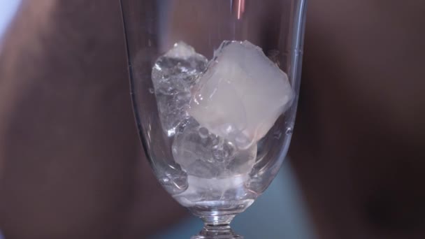 Red liquid pouring  over ice in glass - Metraje, vídeo