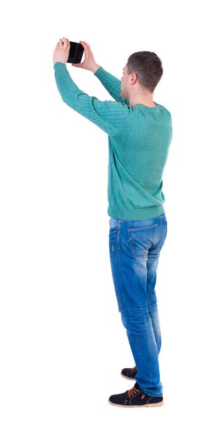back view of standing business man photographing a phone or tabl - Photo, Image