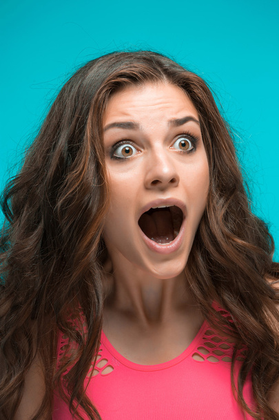 Portrait of young woman with shocked facial expression - 写真・画像