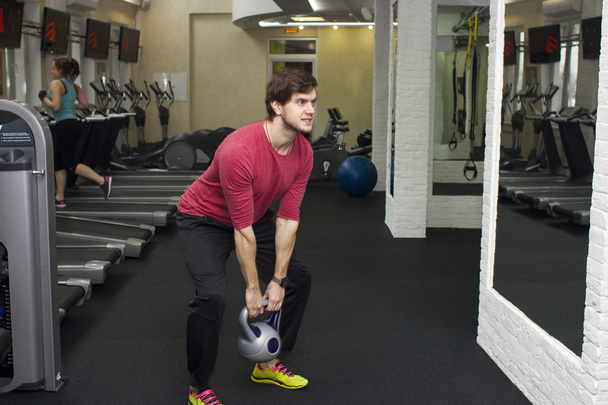 Fitness athletic trainer shows exercises with foarm roll, ball in gym. - Photo, Image