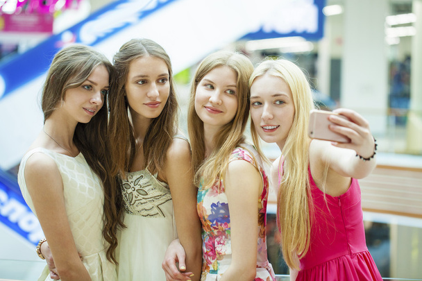 Beautiful, smiling women take a picture of herself with a smart  - Фото, зображення