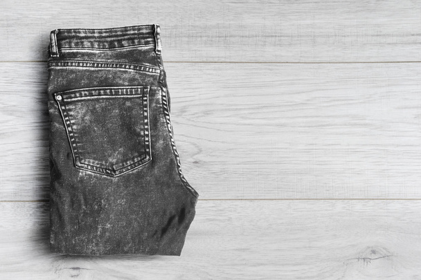 Jeans on wooden background - Фото, зображення