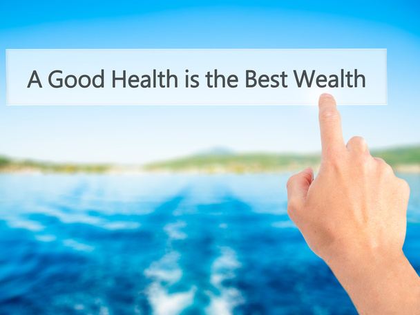 Een goede gezondheid is de beste rijkdom-met de hand drukken op een knop op Blu - Foto, afbeelding