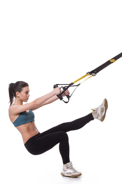 Woman training with suspension trainer sling - Фото, изображение