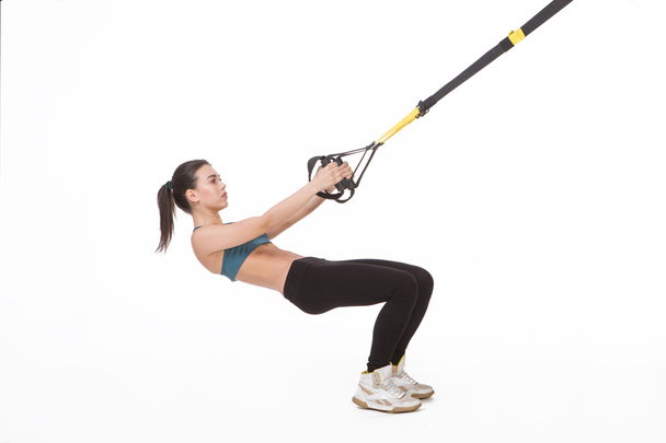 Woman training with suspension trainer sling - Foto, Bild