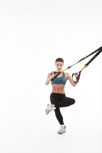 Woman training with suspension trainer sling - Valokuva, kuva