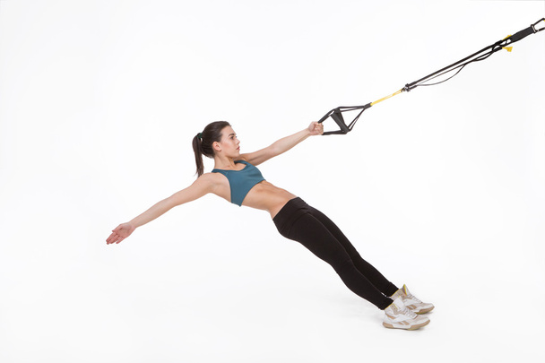 Woman training with suspension trainer sling - Foto, Imagen