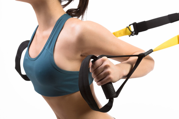Woman training with suspension trainer sling - Fotó, kép