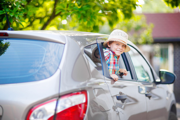 little kid boy sitting in car  just before leaving for vacation - Photo, Image