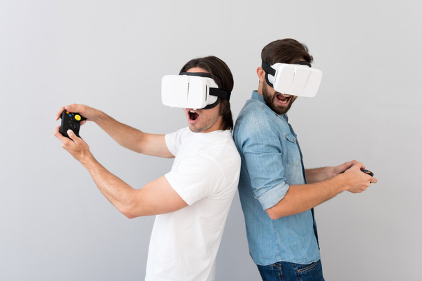 Positive men using virtual reality device - Фото, зображення