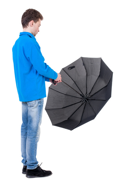 young man in in a white knit sweater under an umbrella - Foto, immagini