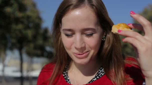 Young beautiful female eating tapas at street - Filmati, video