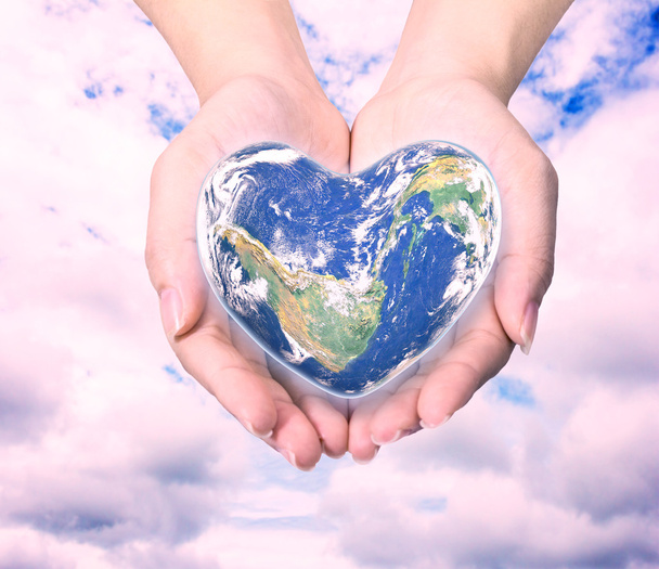 Mundo en forma de corazón con más de las mujeres manos humanas en natu borrosa
 - Foto, Imagen
