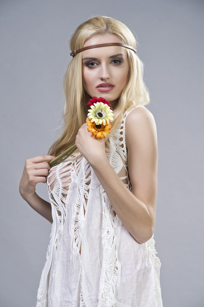 Portrait of young woman with flowers - Foto, Imagen