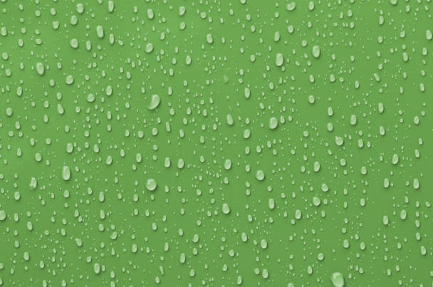 waterdruppels op groen metalen oppervlak - Foto, afbeelding