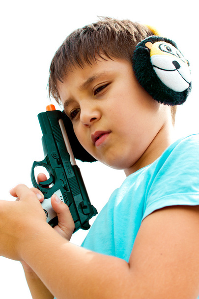 A little boy playing with toy gun - Foto, imagen