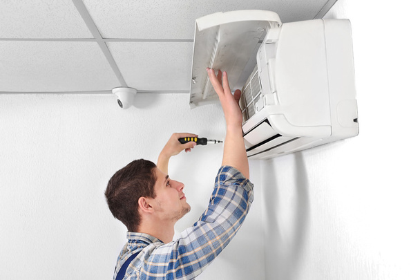 Technician repairing air conditioner  - Фото, зображення