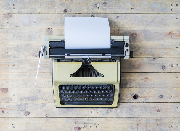 Retro typewriter over wooden background - Fotografie, Obrázek