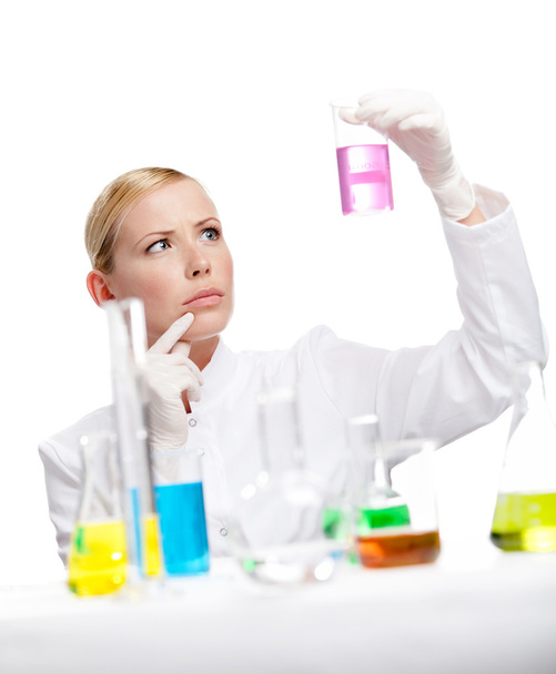 Young lady scientist stares at the beaker - Foto, Imagem