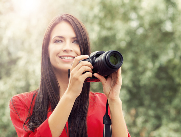 Young and beautiful girl with camera - 写真・画像