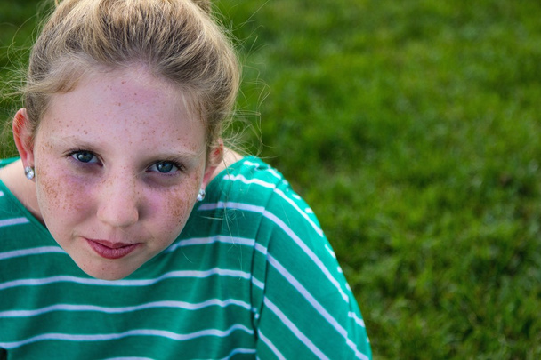 Adolescent young girl on a grassy field. - Fotografie, Obrázek